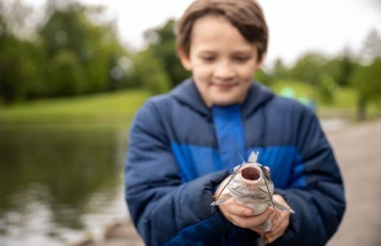 Boy holds catfish